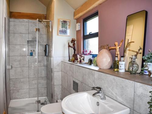 a bathroom with a sink and a shower at The Stables in Heathfield
