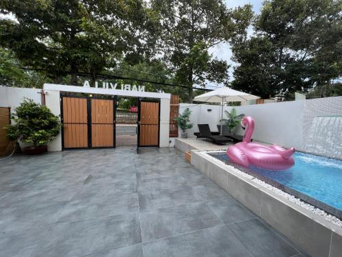 a pool with a pink inflatable flamingo in a backyard at Nancy Sweet Condotel Vung Tau 1 in Vung Tau