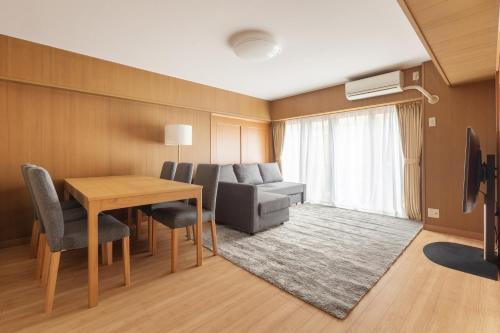 a living room with a table and a couch at A Marvelous Blend of Tradition and Modernity, Independent 1st-floor Suite, Accommodates Up to 10 Guests! in Tokyo