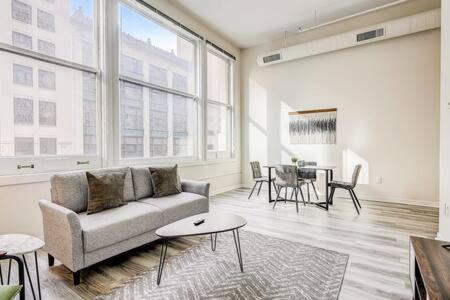 a living room with a couch and a table at CozySuites - 2BR with Direct Skybridge Access #1 in Indianapolis