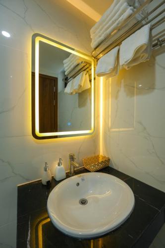 a bathroom with a sink and a mirror at Gia Kiên Hotel in Quy Nhon