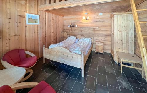 a room with a bed in a wooden cabin at 6 Bedroom Cozy Home In Kvam in Kvam