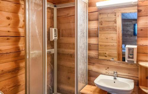 a bathroom with a toilet and a sink and a mirror at 6 Bedroom Cozy Home In Kvam in Kvam