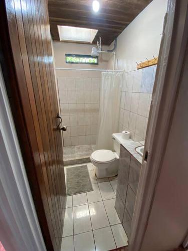a bathroom with a toilet and a sink at Hijos del Bosque in Bijagua