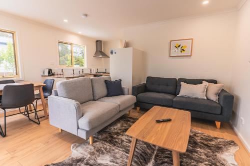 a living room with a couch and a table at BIG4 Tassie Getaway Parks St Helens in St Helens