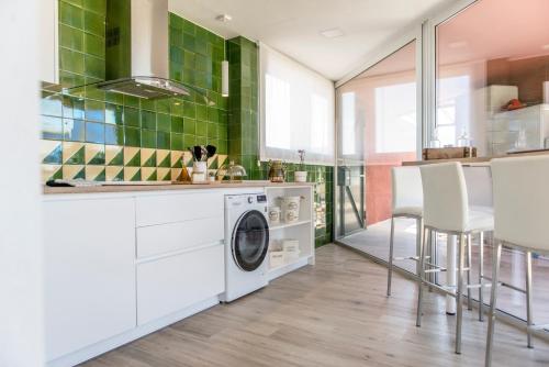 a laundry room with a washer and dryer in a kitchen at La Botigueta de Bellmunt in Penellas