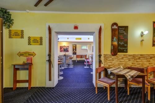 a dining room with tables and chairs in a restaurant at Hotel Andromeda in Ostružná