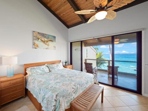 a bedroom with a bed and a view of the ocean at Keauhou sea cliff oceanfront hale in Kailua-Kona