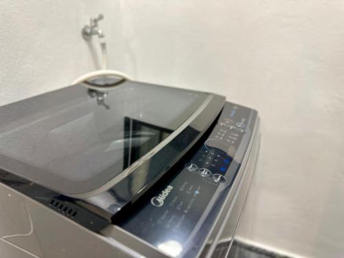 a cell phone sitting on top of a counter at Cozy & Drive Urban Suite by WL in Jelutong