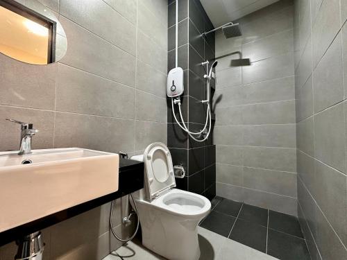 a bathroom with a toilet and a sink at Cozy & Drive Urban Suite by WL in Jelutong