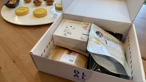 a box of donuts on a table with a plate of doughnuts at 全新根本家民宿 寵物友善 電動麻將 兒童遊戲區 廚房 in Sanxing