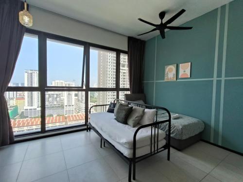 a bedroom with a bed and a large window at Cozy & Drive Urban Suite by WL in Jelutong