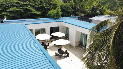 an overhead view of a building with tables and white umbrellas at Fulidhoo Hathaa Retreat in Fulidhoo