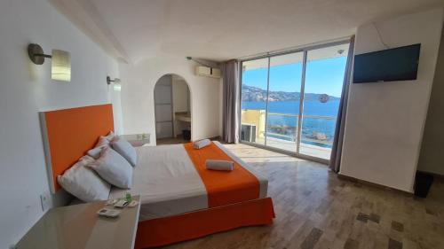 een slaapkamer met een bed en uitzicht op de oceaan bij Romano Palace in Acapulco