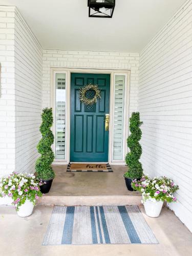 a blue front door of a house with two plants at Swiss Corner Cottage - Private-Heated Indoor Pool in Santa Clara