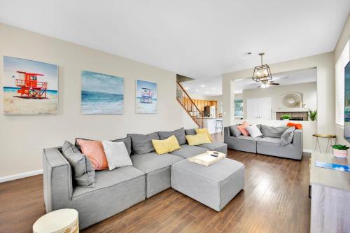 a living room with a gray couch and a table at Seven Palms in Henderson