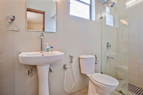 a bathroom with a toilet and a sink and a shower at STAR HOLIDAY VILLAS in Anjuna