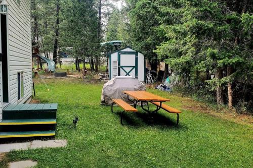 a picnic table in a yard with a tent at EVCharger, Free Parking, Ski, Golf, BBQ, Awesomeness in Invermere