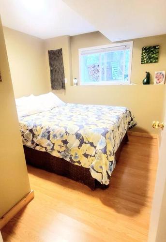 a bedroom with a bed with a quilt on it at EVCharger, Free Parking, Ski, Golf, BBQ, Awesomeness in Invermere