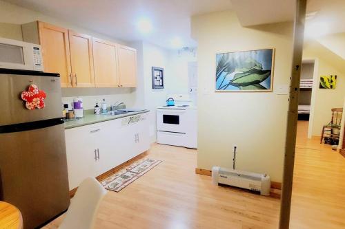 a kitchen with white cabinets and a counter top at EVCharger, Free Parking, Ski, Golf, BBQ, Awesomeness in Invermere