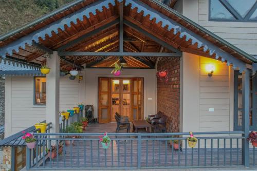 a front porch of a house with a wooden roof at SaffronStays Wood Sparrow in Bhīm Tāl