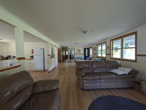 a living room with a couch and a refrigerator at Kiarabilli in Bulwer