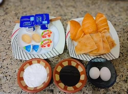 three paper plates of food with eggs and bread at horus desert hotel in Cairo