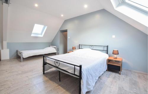 a bedroom with a large bed and two night stands at Nice Home In Quettehou With Kitchen in Quettehou