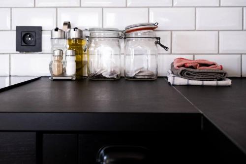 a kitchen counter with jars on top of it at Loft du presbytère - Calme et nature in Beauraing
