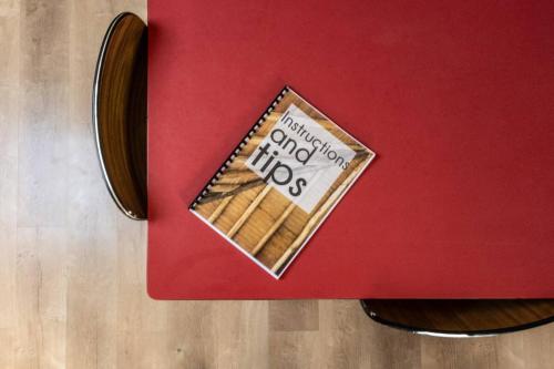 a piece of cake on top of a red table at Loft du presbytère - Calme et nature in Beauraing