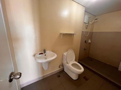 a bathroom with a toilet and a sink at Avida Asten Makati Long Term Lease in Manila