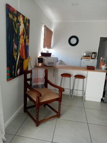 a kitchen with a chair next to a counter at Lor's Place in Mount Road
