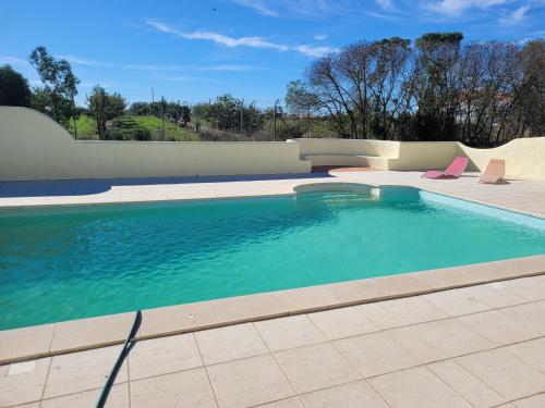 a swimming pool with two lounge chairs in a pool at Quinta da Belavista in Reguengos de Monsaraz