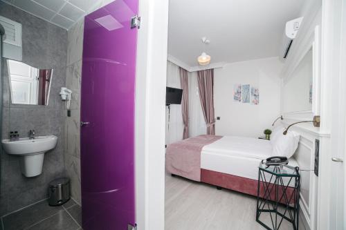 a hotel room with a bed and a sink at Nun By Laren Hotels in Antalya