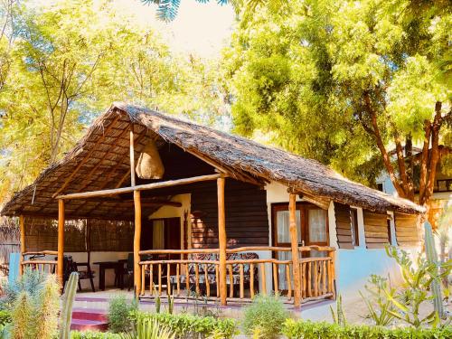 a log cabin with a thatched roof at VOVO TELO LODGE in Toliara