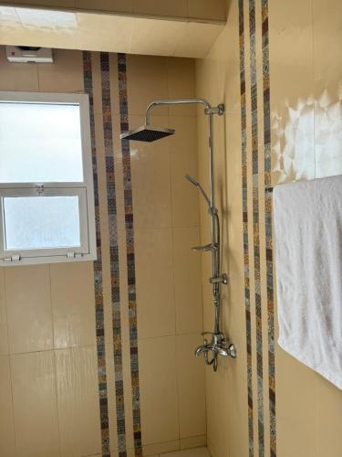 a bathroom with a shower and a window at Marhaba Retreats in Muscat