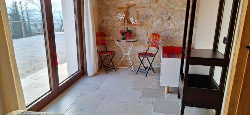 a room with a table and chairs and a table at Agriturismo La Pina in Tarzo
