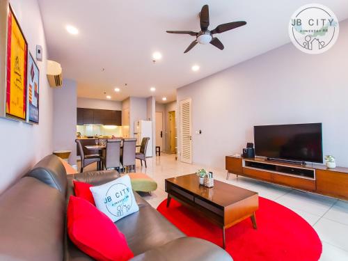 a living room with a couch and a flat screen tv at Puteri Harbour by RR JBcity in Nusajaya