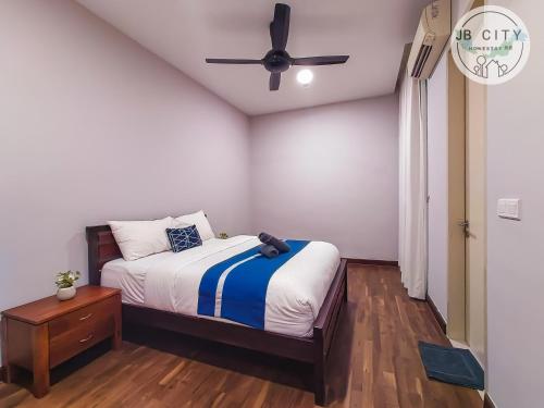 a bedroom with a bed and a ceiling fan at Puteri Harbour by RR JBcity in Nusajaya