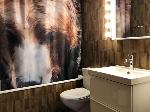 a bathroom with a horse shower curtain and a toilet at Central City - inkl Parking and Bern Ticket in Bern