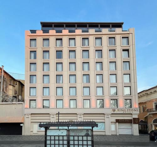 a large tan building with a sign on it at Ring Stone Hotels Bosphorus - Special Class in Istanbul