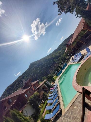 a view of a resort with a swimming pool and a mountain at Gasthaus Maria in Borlova