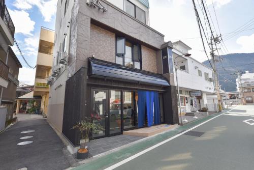 un edificio al lado de una calle en 4S STAY Awaikeda ikedaonsenyoko, en Miyoshi