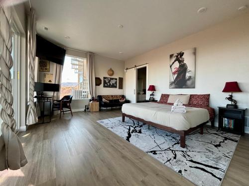a bedroom with a bed and a living room at Page Arizona border town- Crimson Suite, Desert Canyon Getaway with views in Big Water
