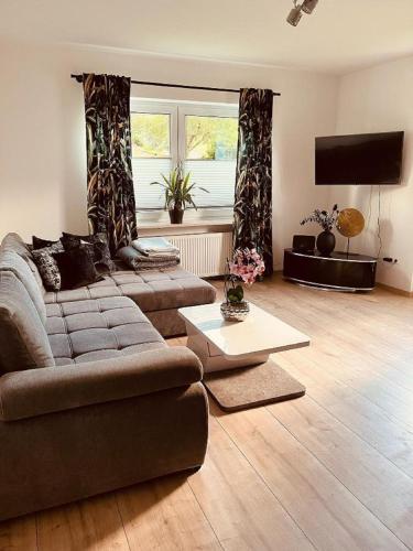 a living room with a couch and a flat screen tv at Ferienwohnung Elfi in Kirchdorf im Wald