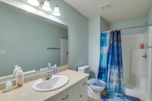 a bathroom with a sink and a toilet and a mirror at Charming Retreat With Modern Comforts in West Fargo
