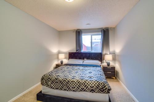 a bedroom with a bed and two lamps and a window at Charming Retreat With Modern Comforts in West Fargo
