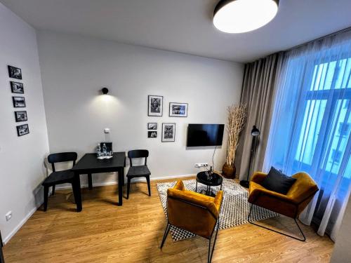 a living room with a table and chairs at Home Heart of the center of Brno - Koliště Passage in Brno