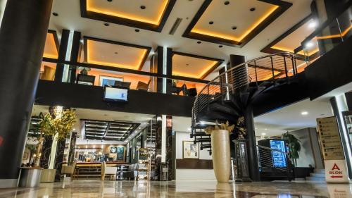 a lobby with a staircase in a building at Suhan Cappadocia Hotel & Spa in Avanos