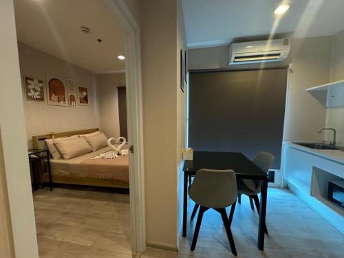 a room with a table and a bedroom with a bed at Near central westgate at bangyai 80 in Ban Bang Krabu